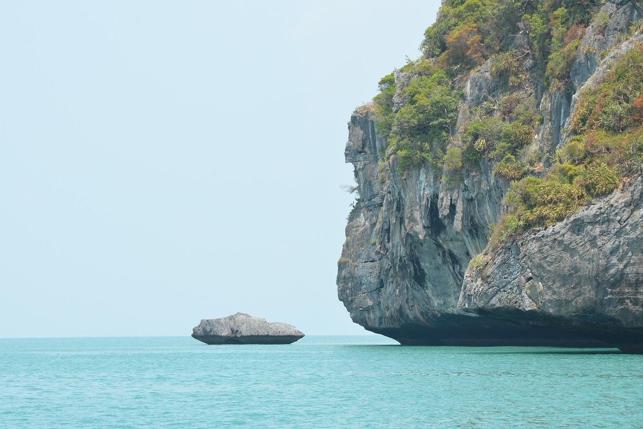 Emerald limestone karsts rising from turquoise waters at Ang Thong Marine Park, Thailand