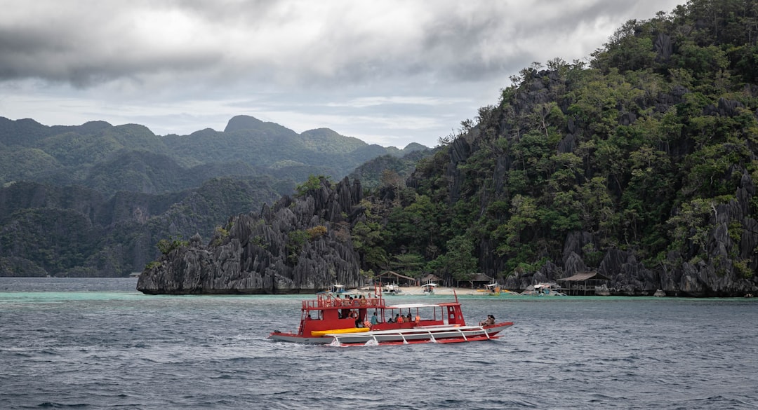 Limestone cliffs rising from turquoise water near Coron, Palawan