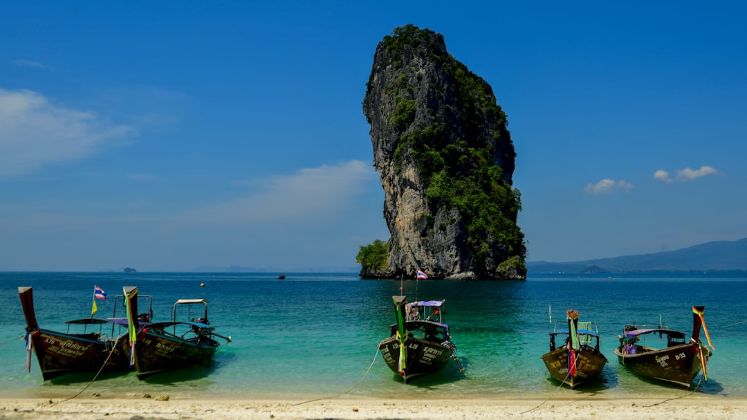 Traditional longtail boat near limestone islands off Phuket
